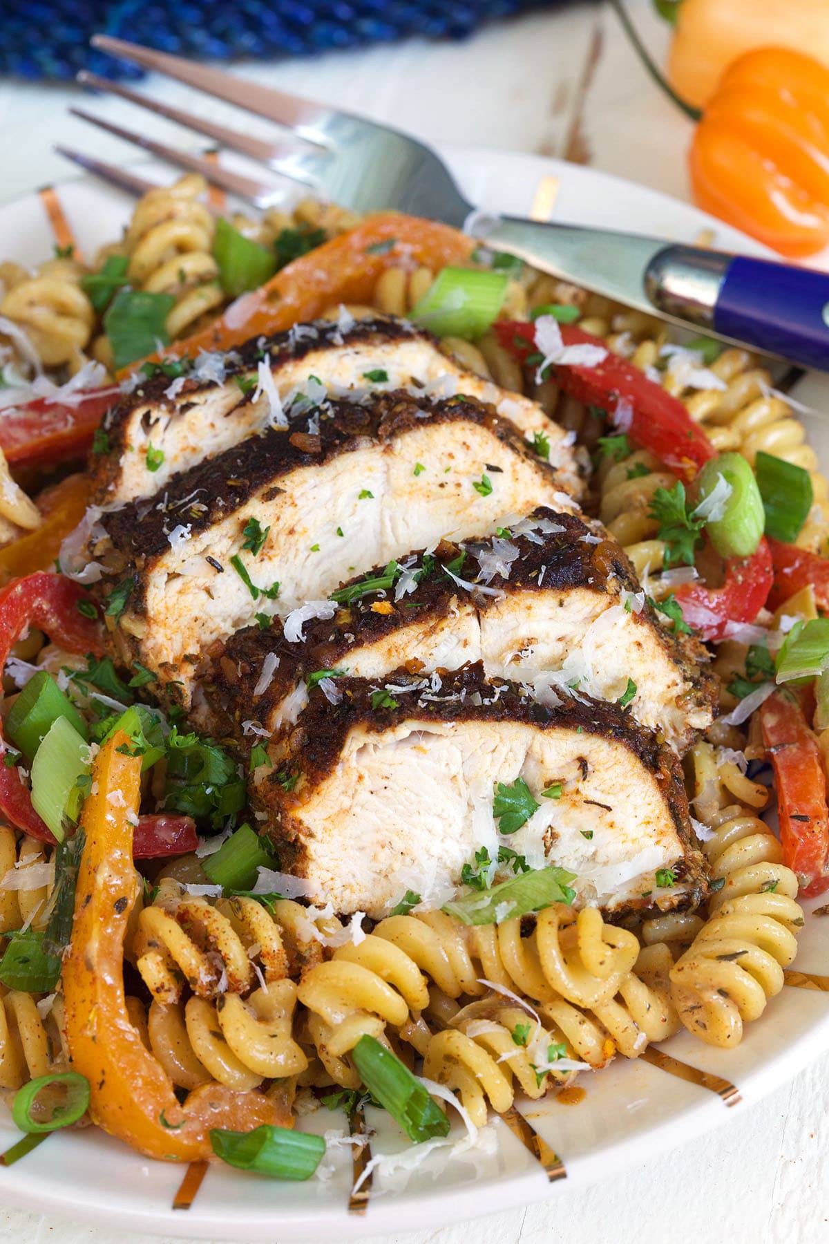 Chicken is sliced and placed on top of pasta.