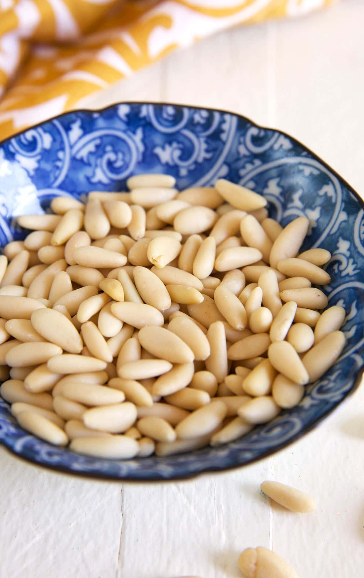 Pine nuts are placed in a small bowl. 
