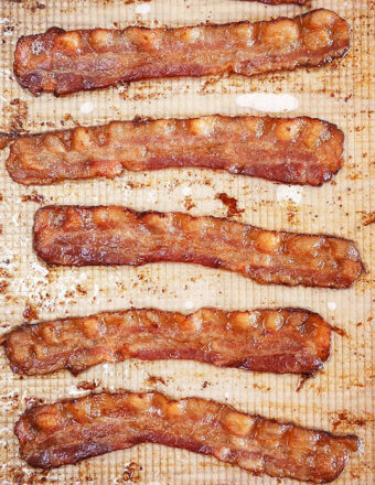 Oven Baked Bacon on a baking sheet with parchment paper.