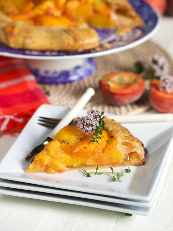 A slice of galette is plated with a fork and knife.