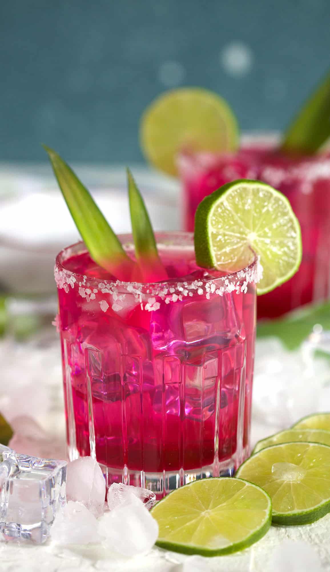 A glass filled with margarita is ready to be enjoyed on a white surface.