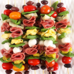 Overhead shot of Antipasto skewers on a white square plate