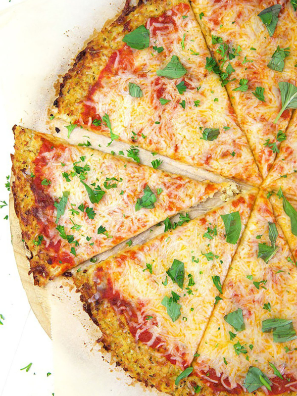 Cauliflower Pizza crust with sauce and cheese.