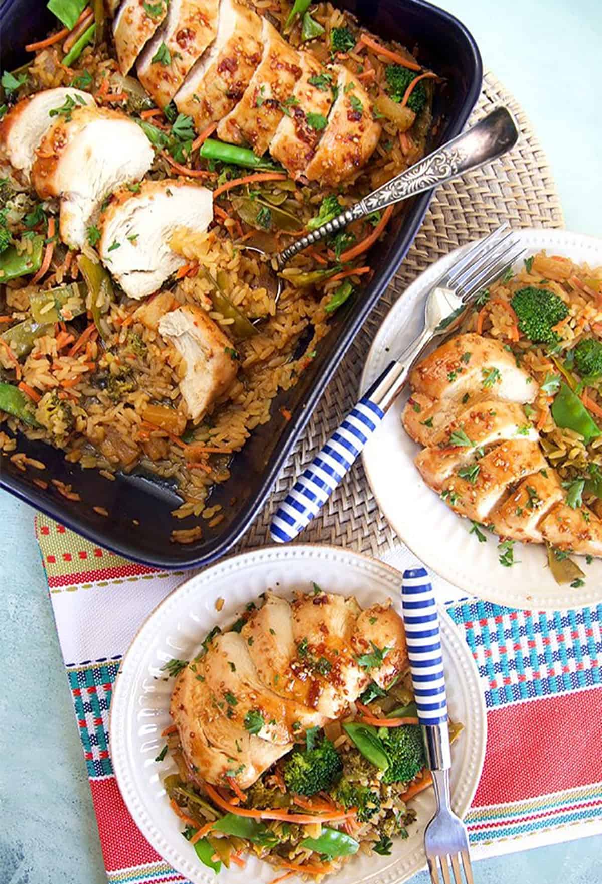 Overhead shot of Baked Teriyaki Chicken Casserole in a blue casserole on a light blue background.