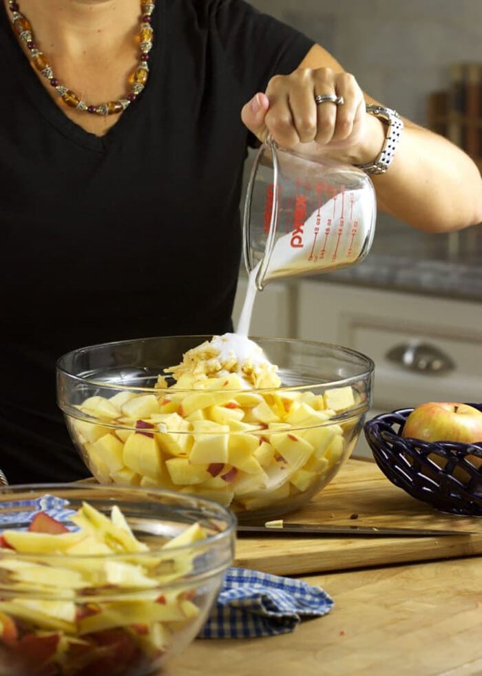 Ingredients for apple crisp being combined in a glass bowl