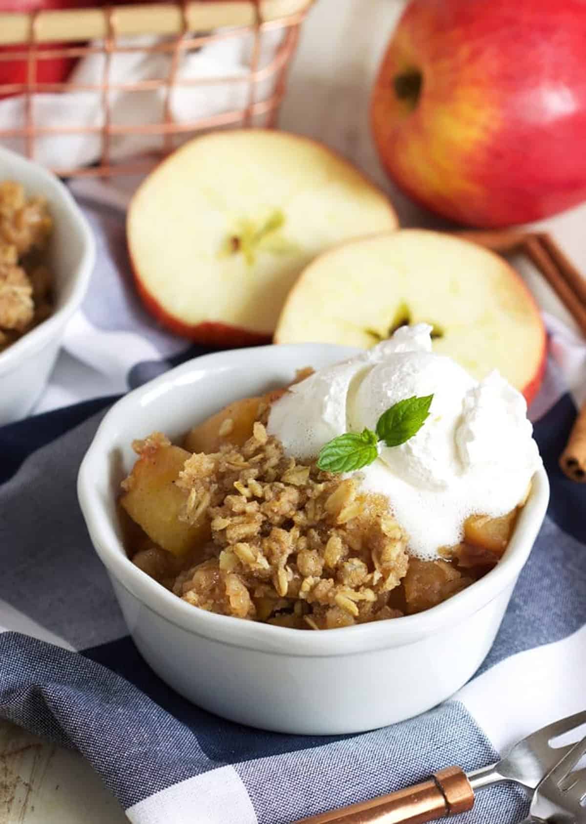 Apple Crisp in a white ramekin with ice cream on top