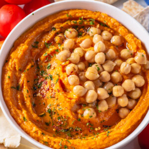 Pumpkin hummus is topped with chickpeas.