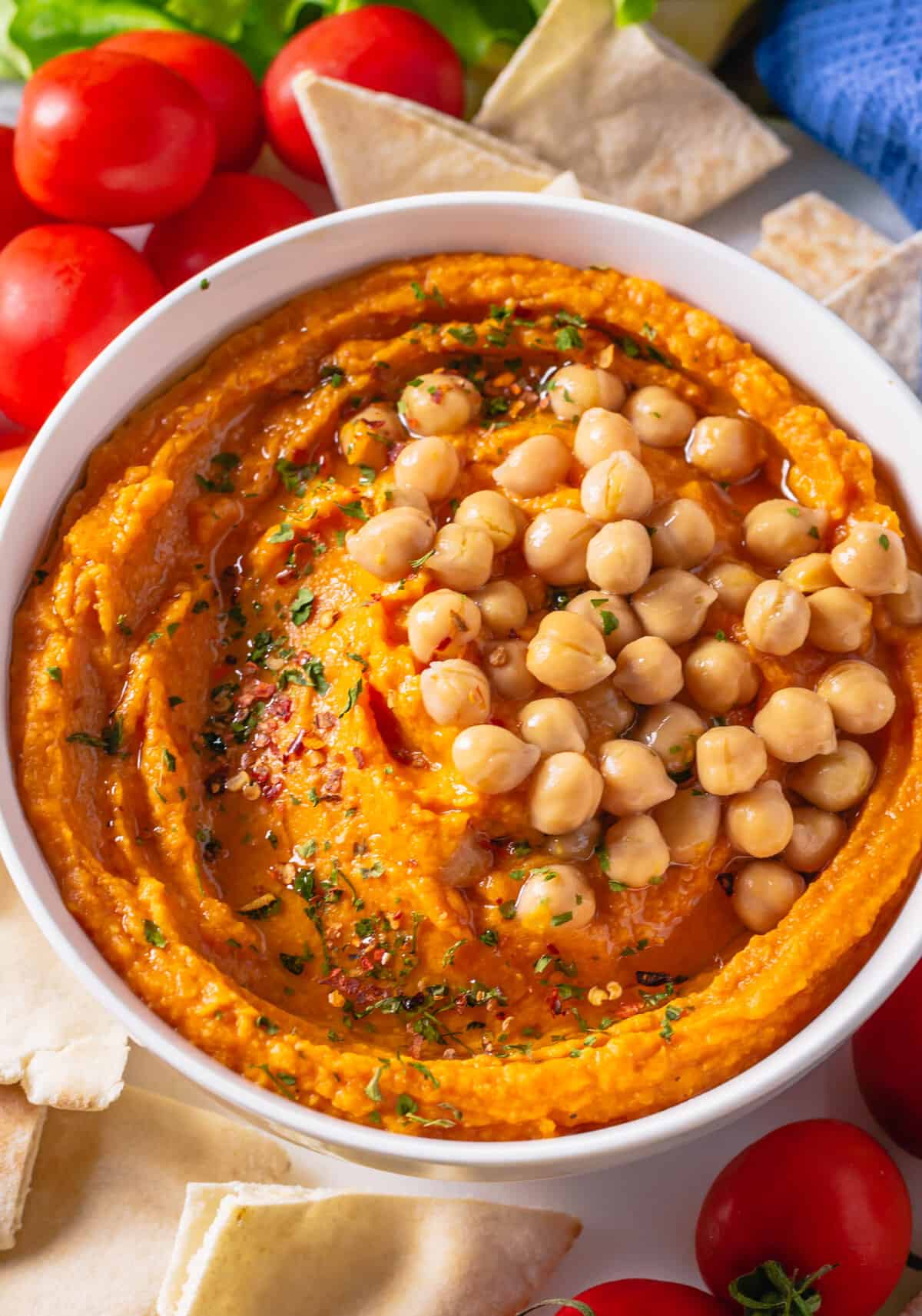Pumpkin hummus is topped with chickpeas. 