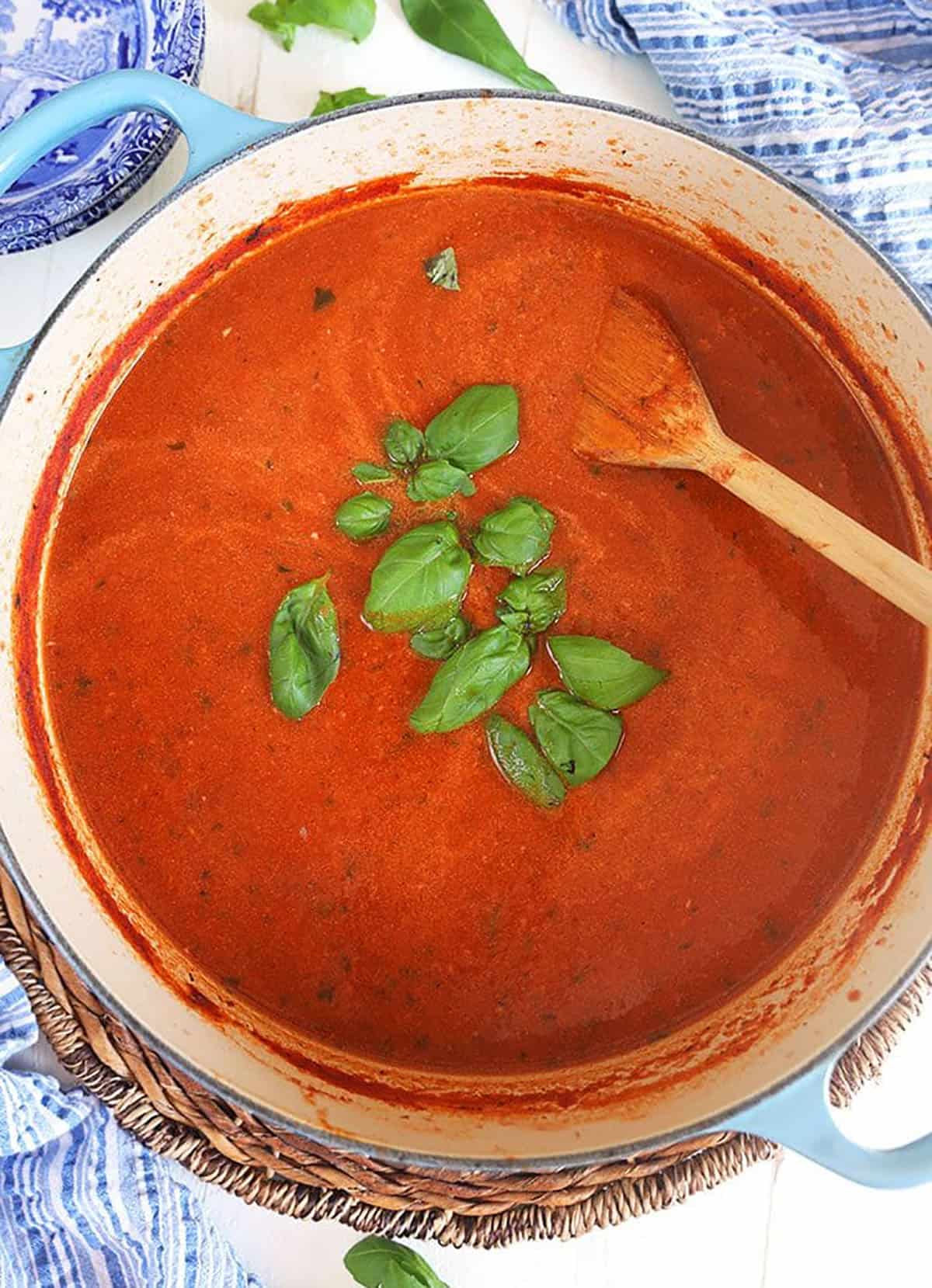 Overhead shot of Tomato Basil Bisque in a blue stock pot.