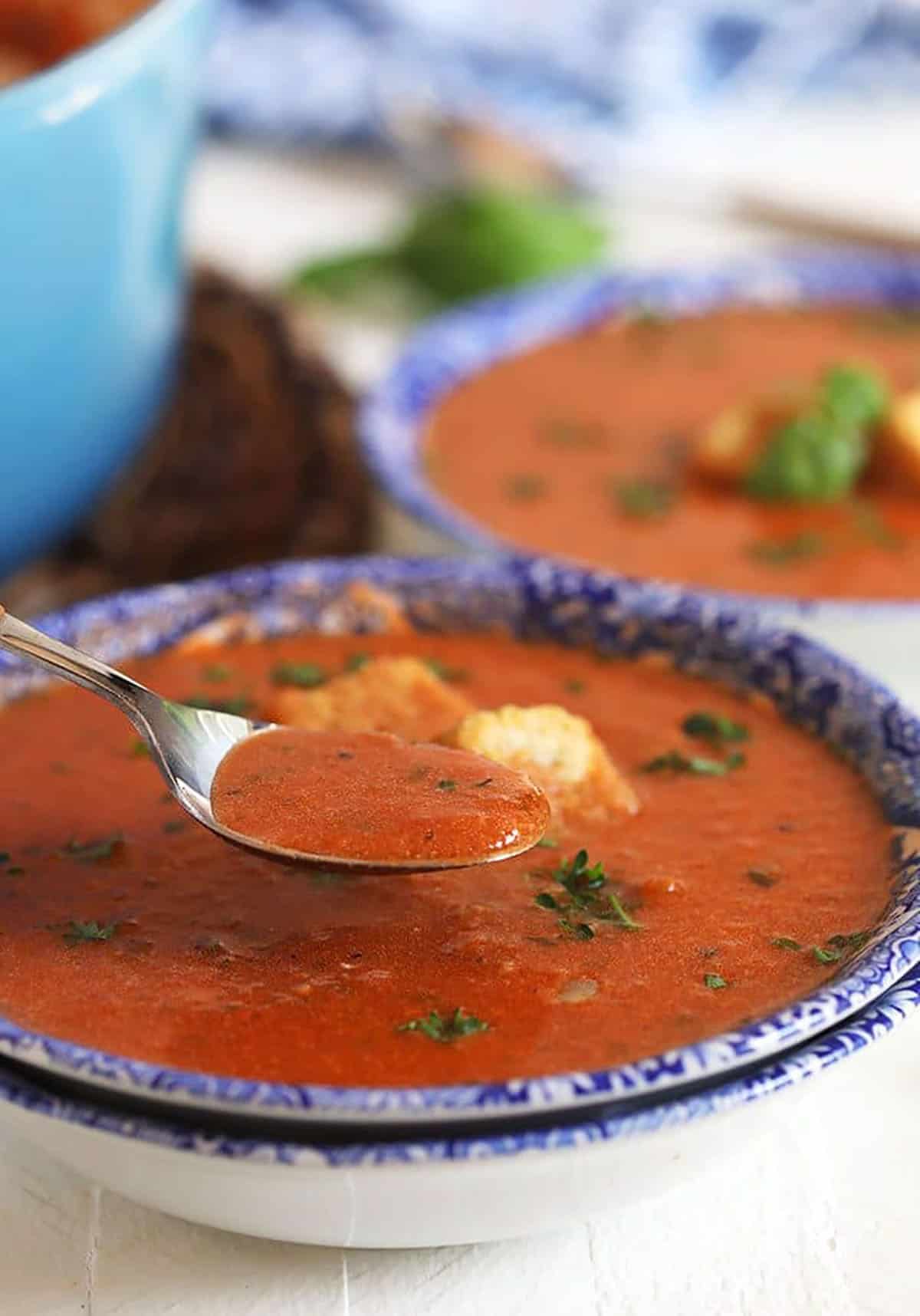 Tomato Basil Bisque with a spoon in it.