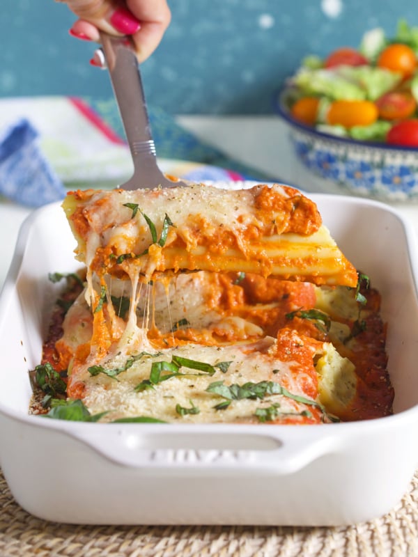 Manicotti being served with a spatula