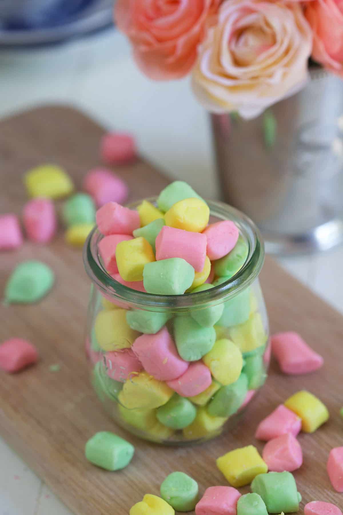 Colorful butter mints are in a small glass.