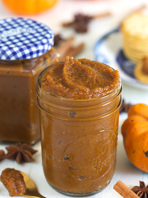 A jar is filled to the brim with pumpkin butter.