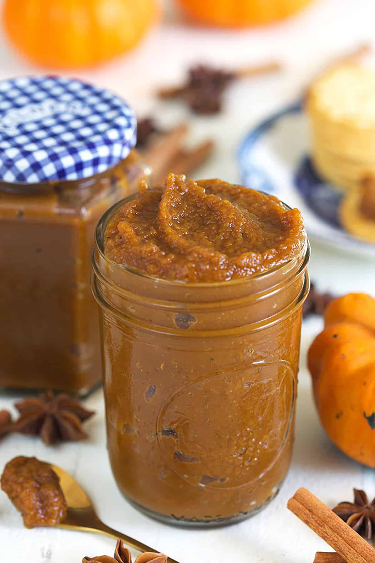 A jar is filled to the brim with pumpkin butter.