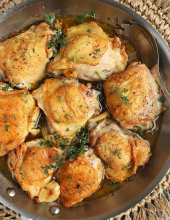 Overhead shot of Crispy Baked Chicken Thighs in a skillet.