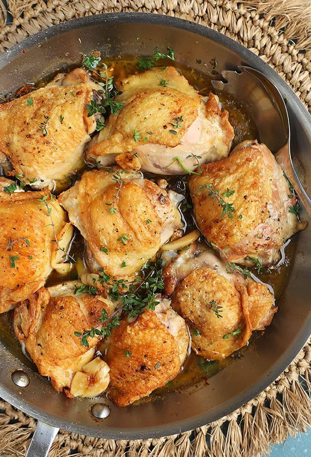 Overhead shot of Crispy Baked Chicken Thighs in a skillet.