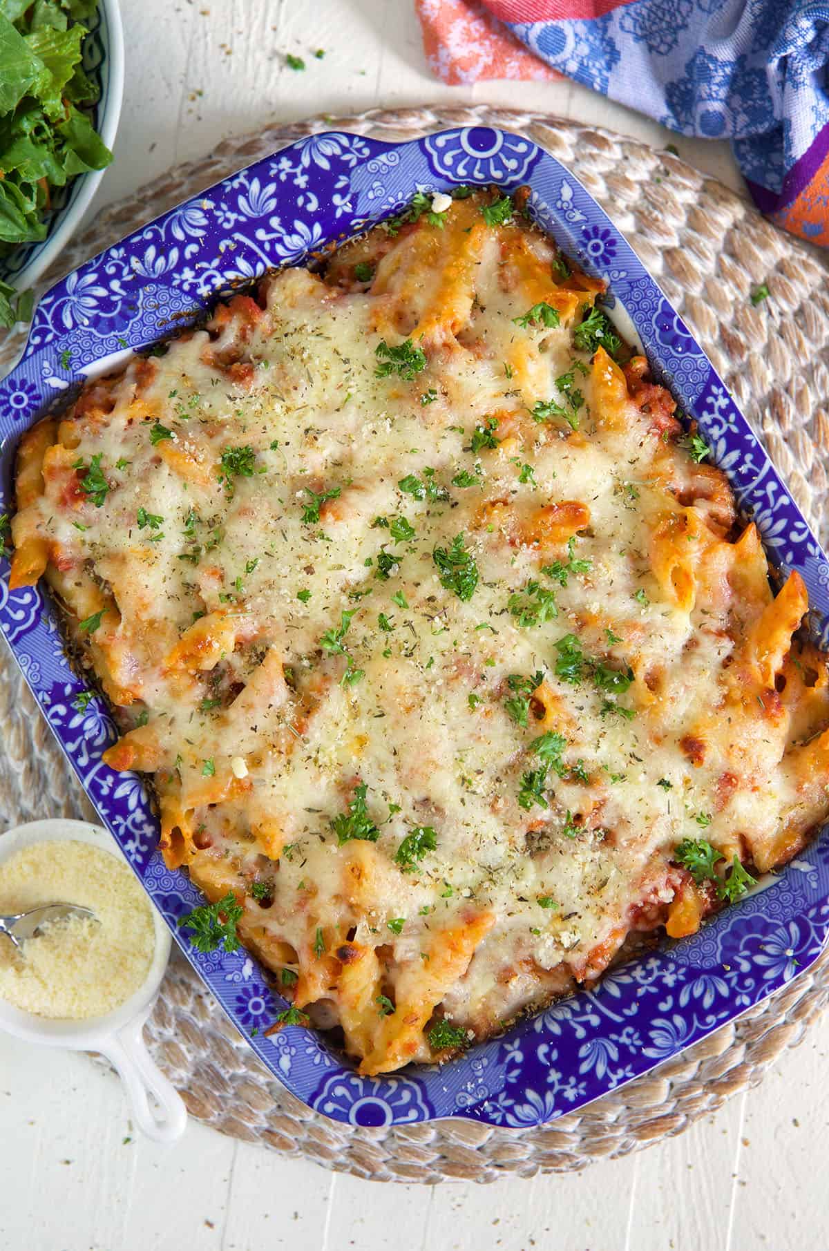 Mostaccioli is baked to perfection and garnished with a sprinkle of fresh parsley.