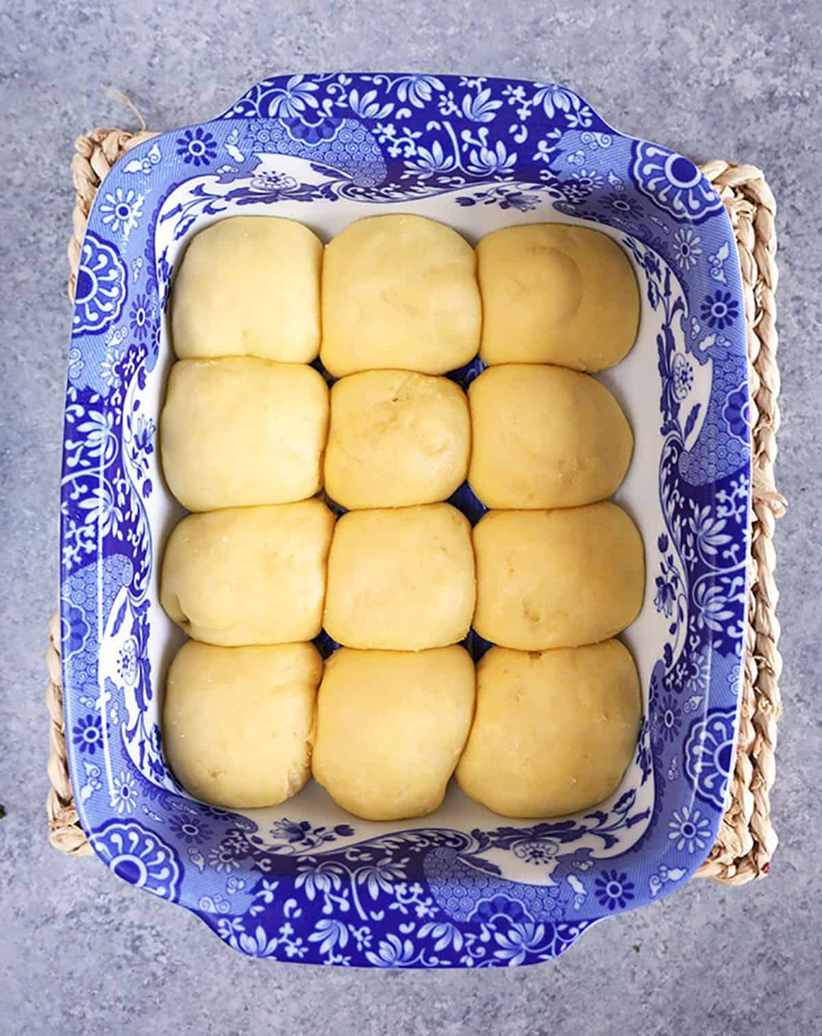 Dinner rolls in a baking dish before baking.