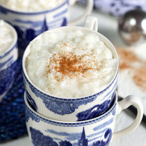 Rice pudding in a blue and white tea cup stacked in another tea cup.