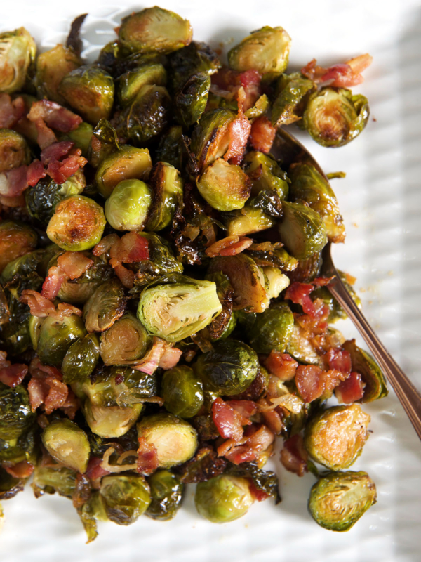 A serving spoon is placed next to a heaping portion of bacon brussel sprouts.