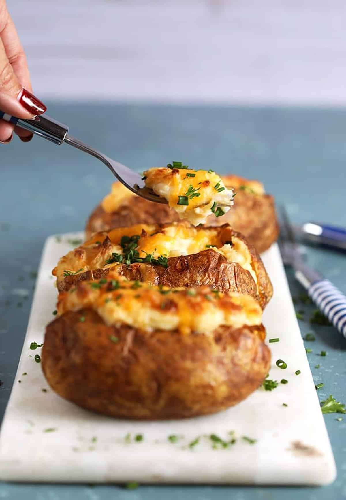 Easy Twice Baked Potatoes with a fork taking a bite.