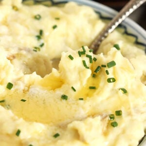 Mashed Potatoes topped with melted butter and sprinkled with chives.