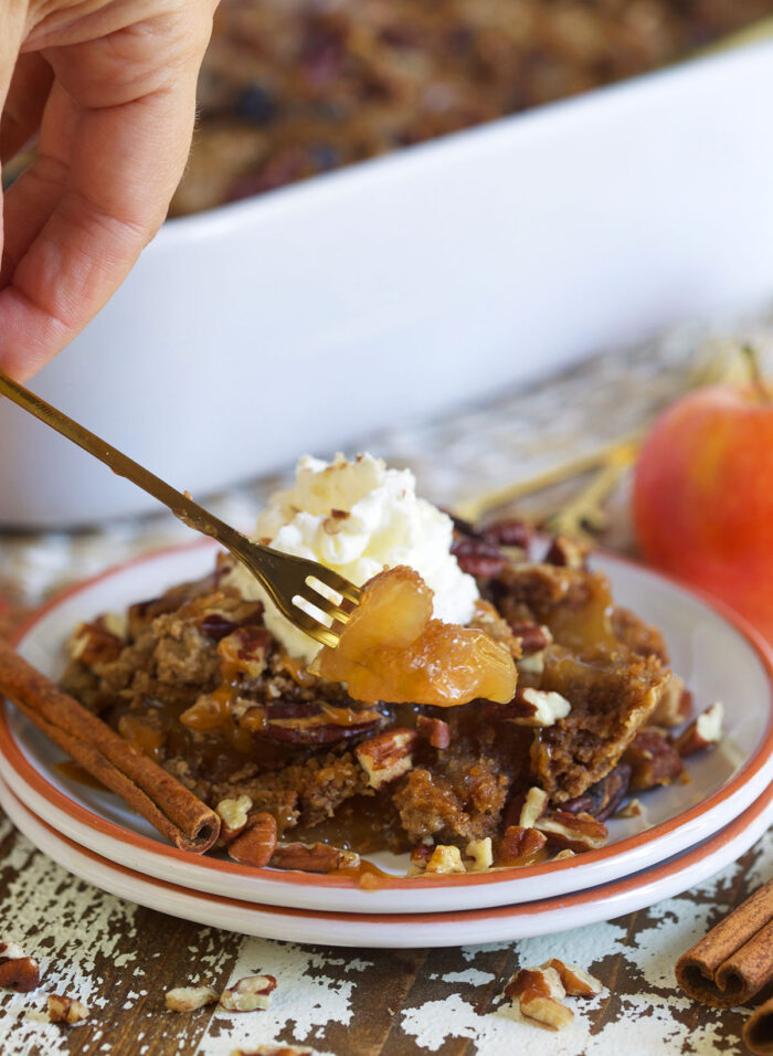 A serving of apple dump cake is presented on a small white plate.