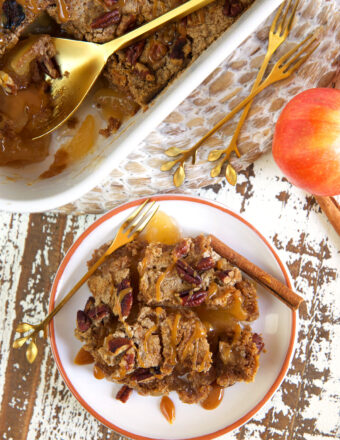 A serving of apple dump cake is presented on a white plate next to a dish filled with more cake.