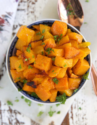 A bowl is filled to the brim with roasted butternut squash.