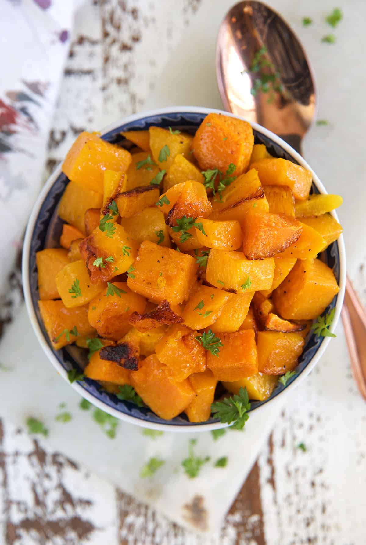 A bowl is filled to the brim with roasted butternut squash.