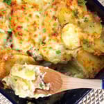 Overhead shot of scalloped potatoes and ham casserole in a baking dish.