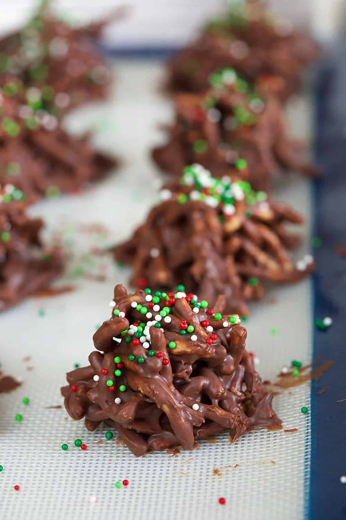 Chocolate haystack cookies on a baking sheet.
