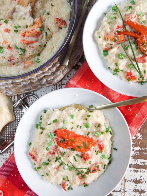 Two bowls of risotto are placed next to a half full pot.