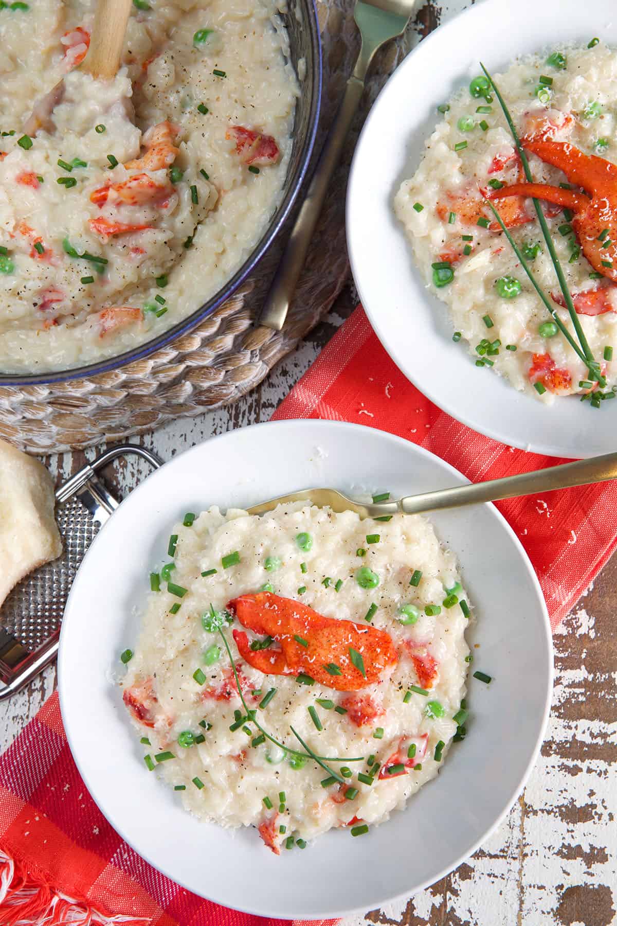 Two bowls of risotto are placed next to a half full pot.