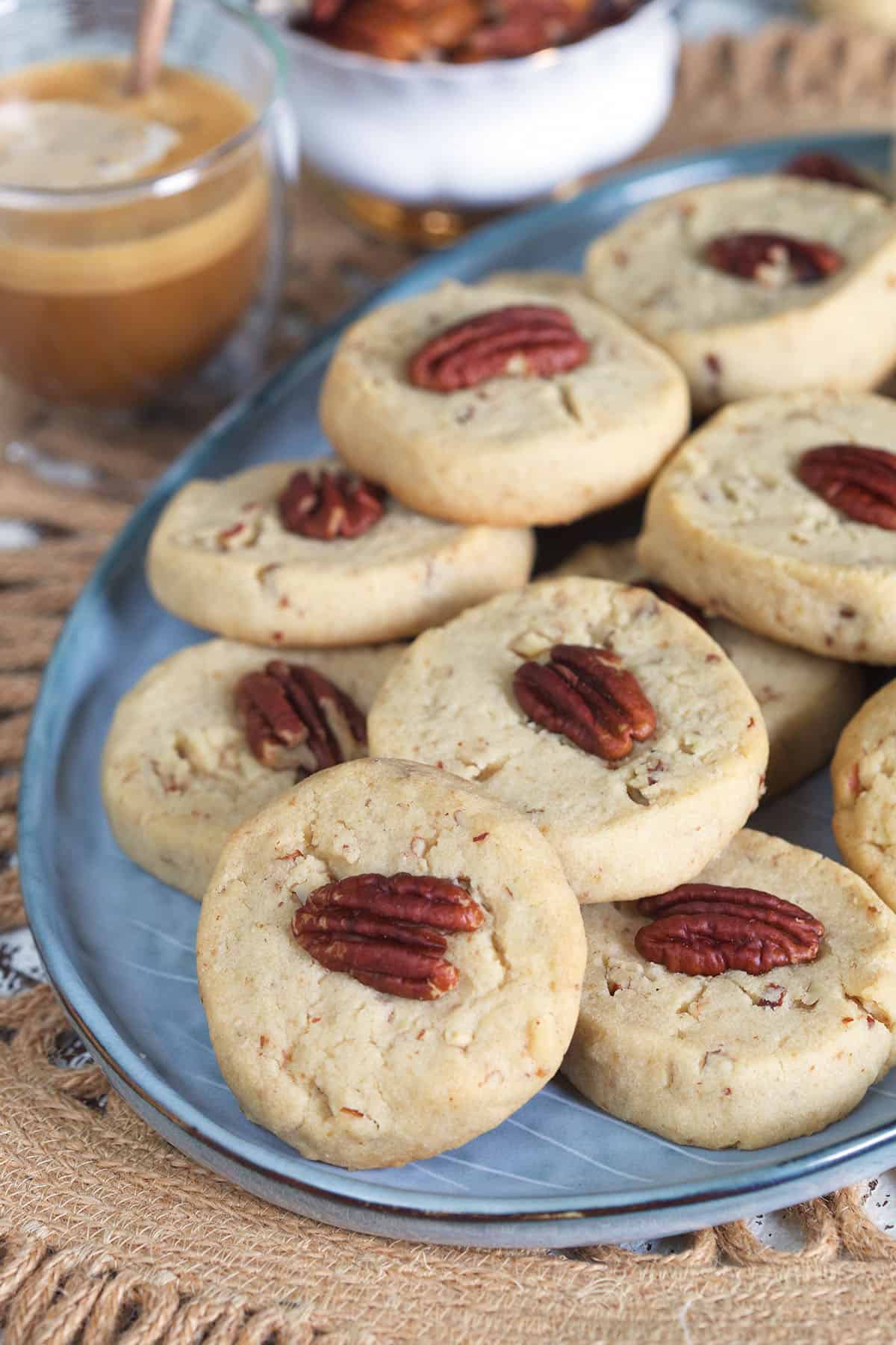 An oval shaped serving tray is topped off with a batch of pecan sandies.