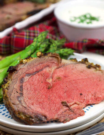 slice of prime rib on a white plate.