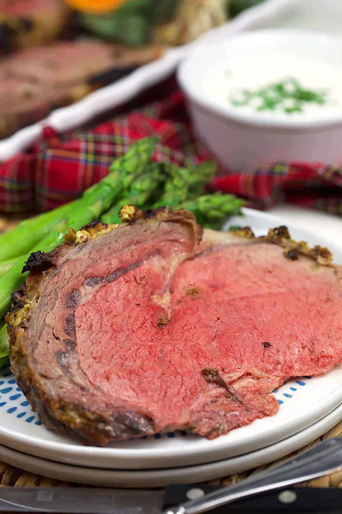 slice of prime rib on a white plate.