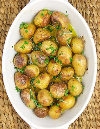 Overhead shot of baby potatoes in a white staub casserole.