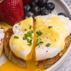 A poached egg has been cut in half to reveal the perfectly runny yolk.