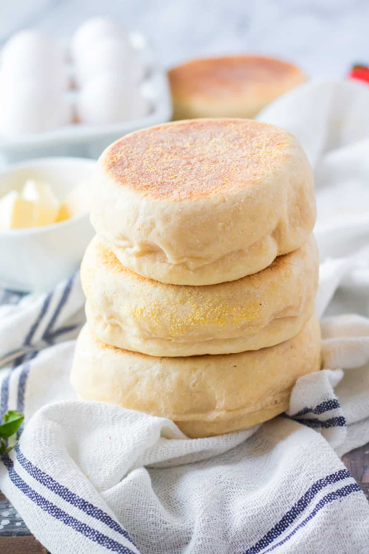 Three english muffins are stacked on top of one another.