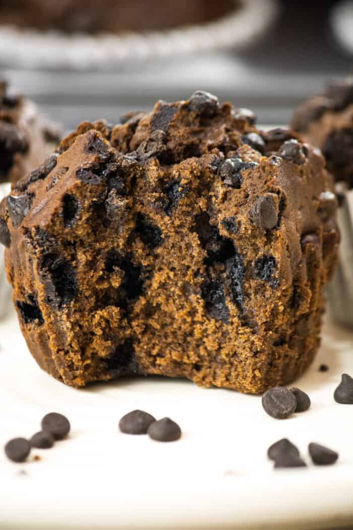 A muffin has been bitten into, revealing a cooked through center.