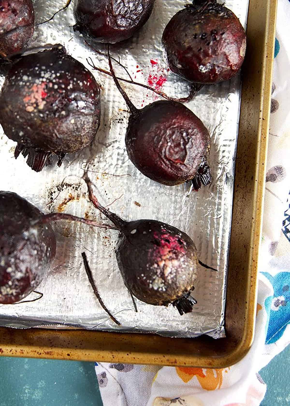 Overhead shot of roasted beets on a baking sheet.
