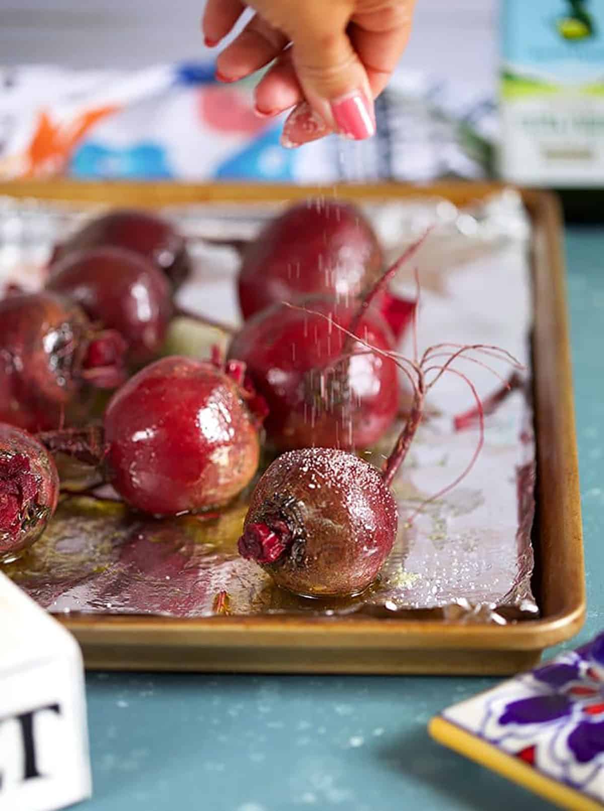 Beets on a baking sheet with olive oil and salt.