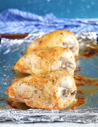 Roasted chicken breast on a baking sheet.