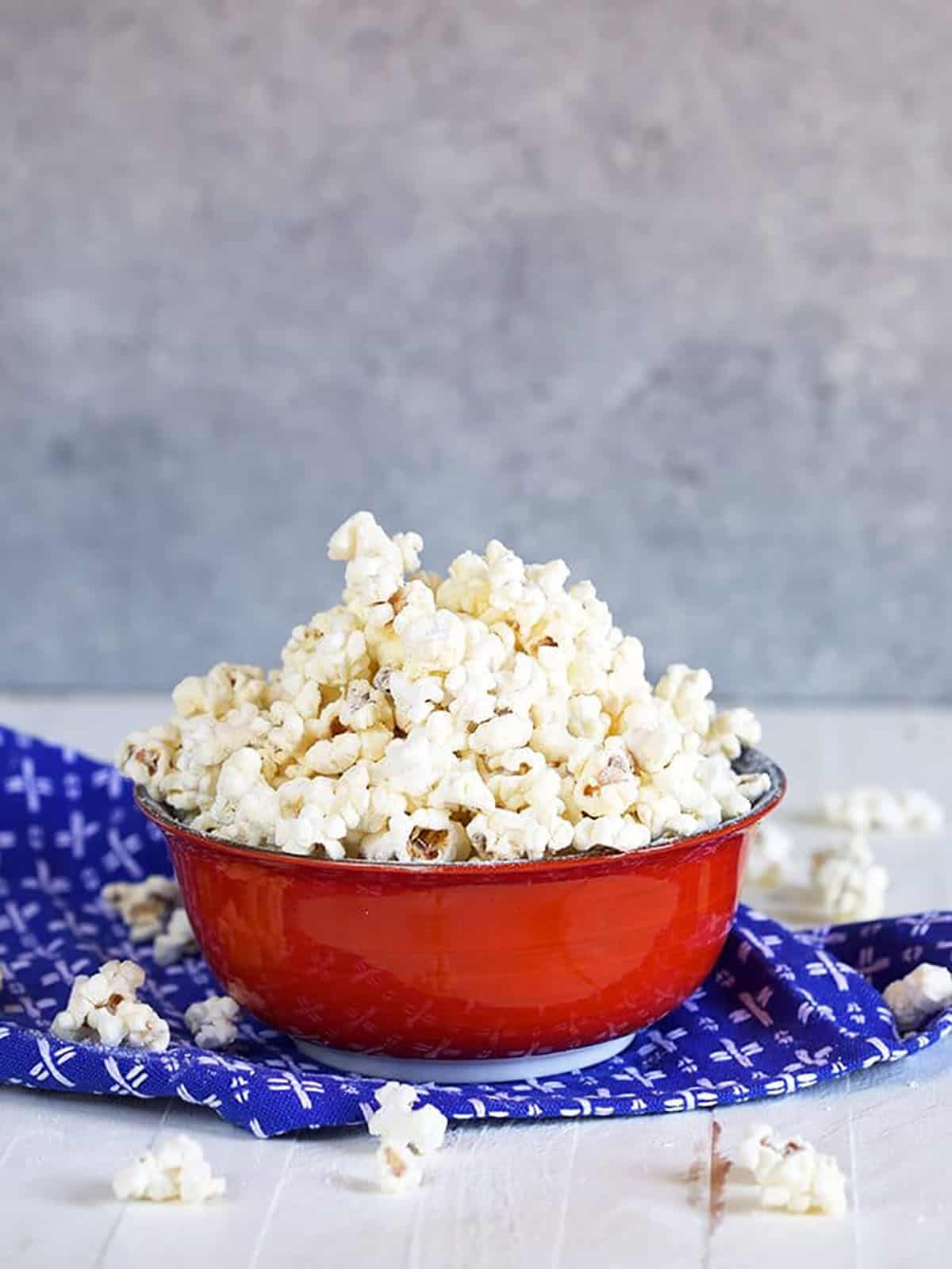 white cheddar popcorn in a red bowl.
