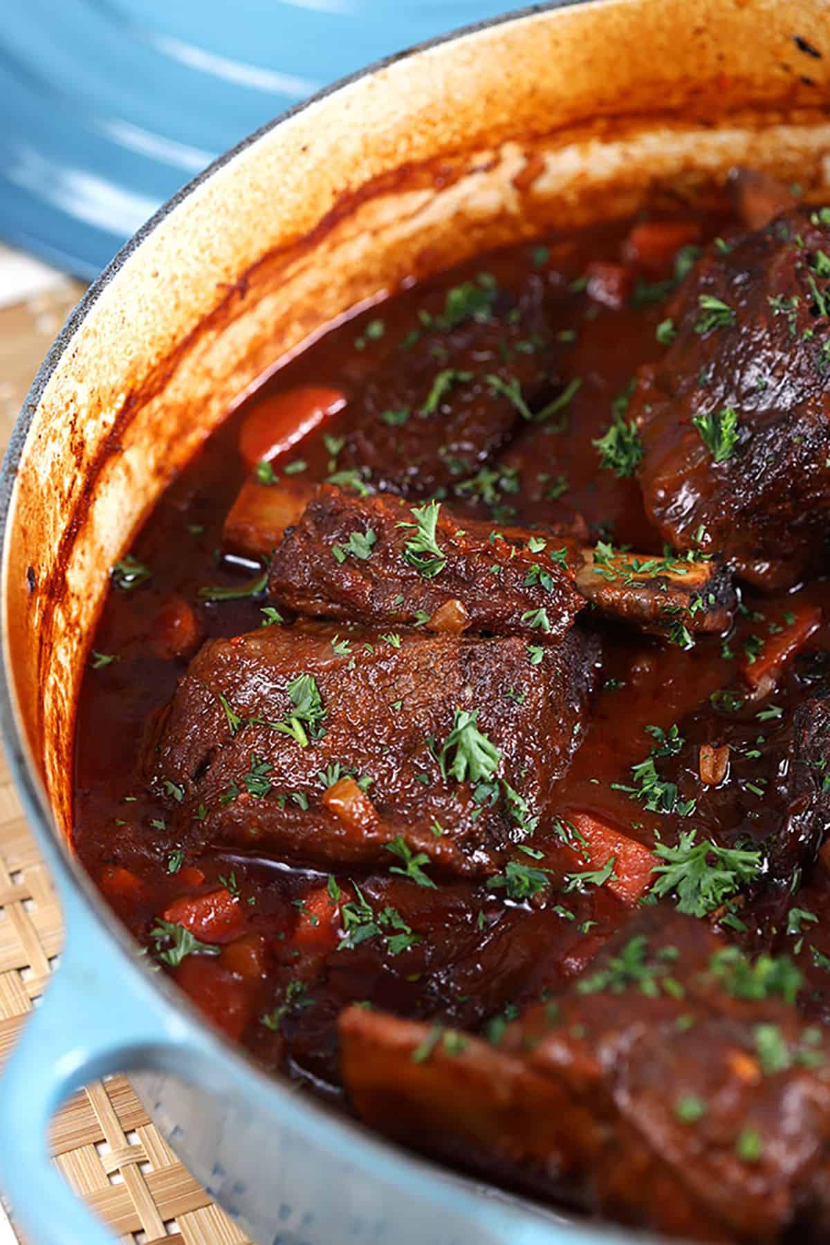 Braised Short Ribs in blue Le Creuset dutch oven 