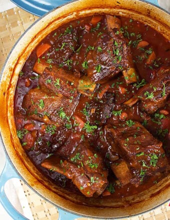 Sweet and spicy Honey Chipotle Braised Short Ribs in a blue Le Creuset Braisier