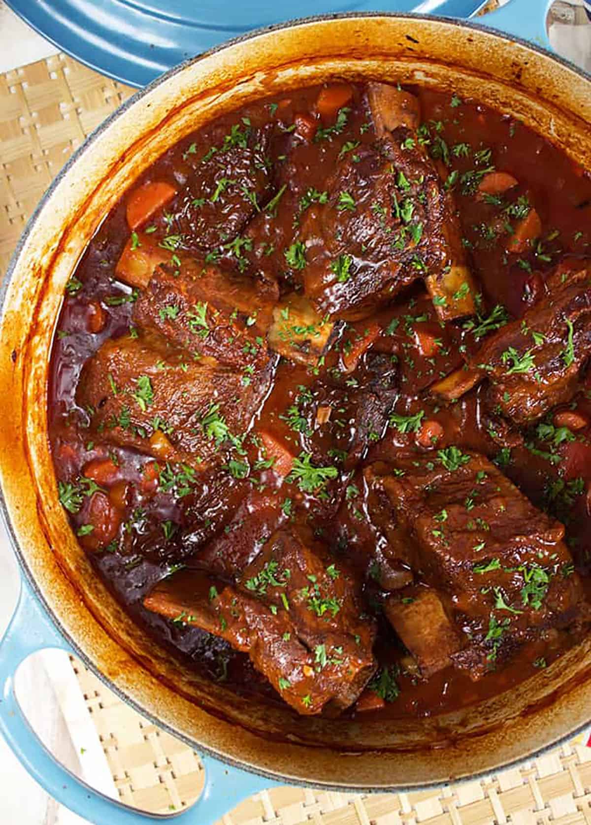 Sweet and spicy Honey Chipotle Braised Short Ribs in a blue Le Creuset Braisier