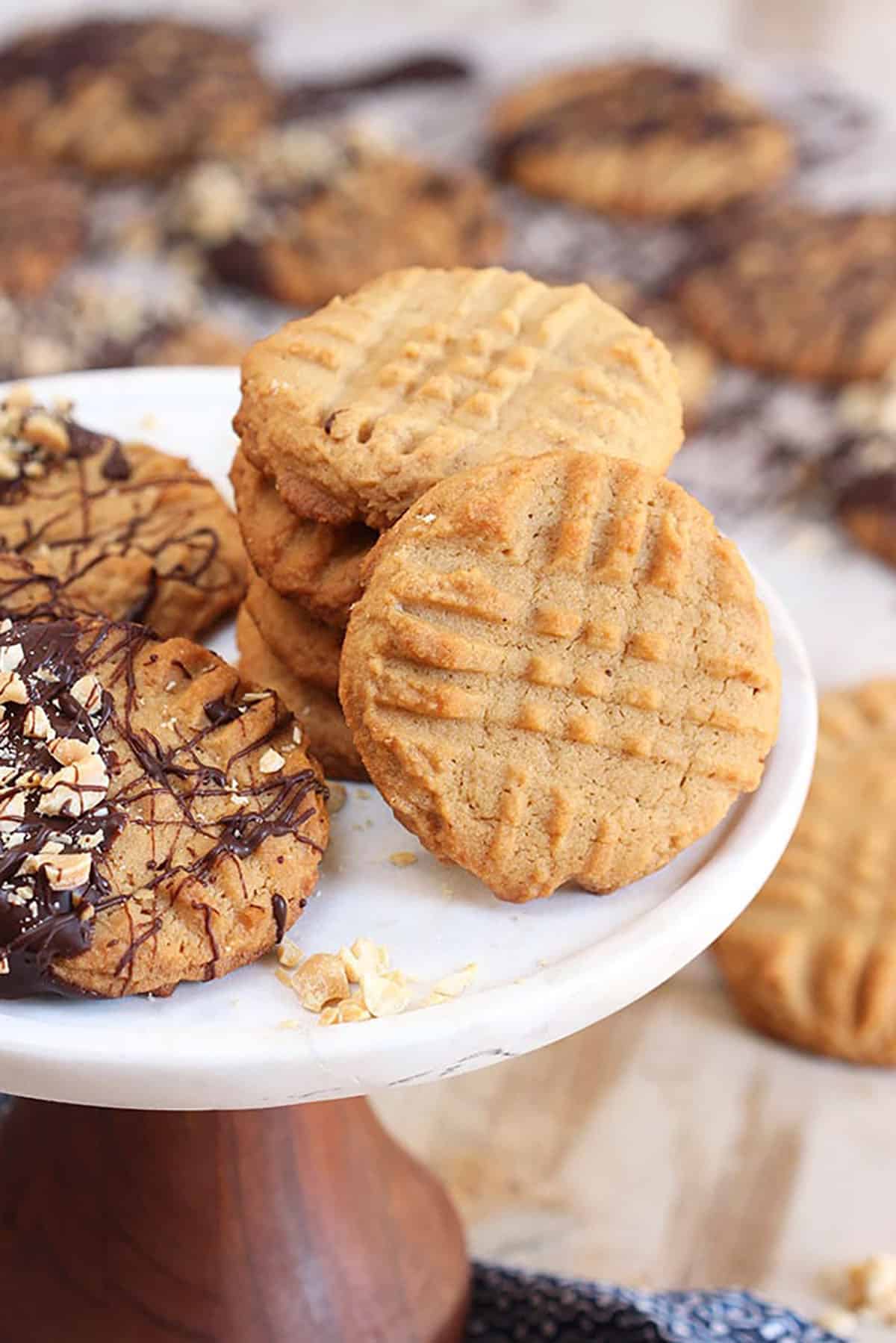 Peanut Butter cookies stacked on a marble cake plate