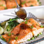 Baked Teriyaki Salmon with teriyaki sauce being drizzled on top with a spoon.